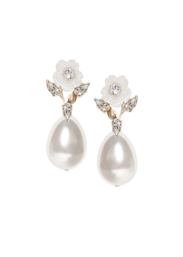 A pair of pearl tear drop earrings with hand carved mother of pearl flowers and crystal accents, displayed against a white background.