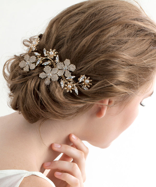 Golden floral bridal hairpiece on model back view 
