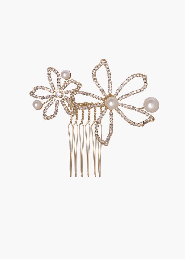 Gold hair comb with floral designs and pearls on a white background