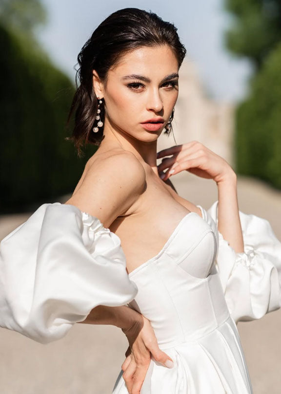 simple pearl drop earring on model in puff sleeved wedding dress in france