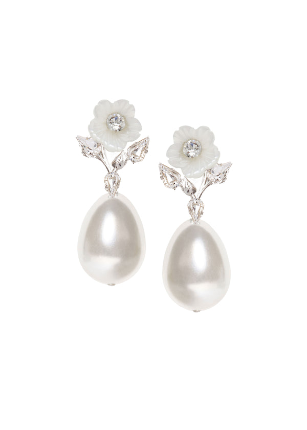 A pair of floral pearl earrings topped with a mother of pearl flowers and crystals on a white background 