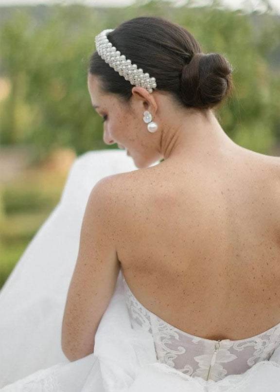 Pearl headband on bride in wedding dress