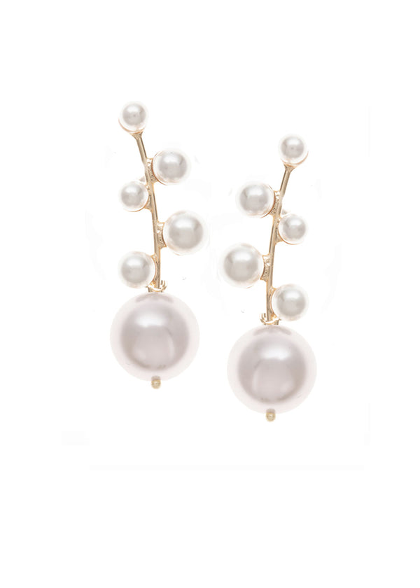 A gold and pearl drop earring on a white background