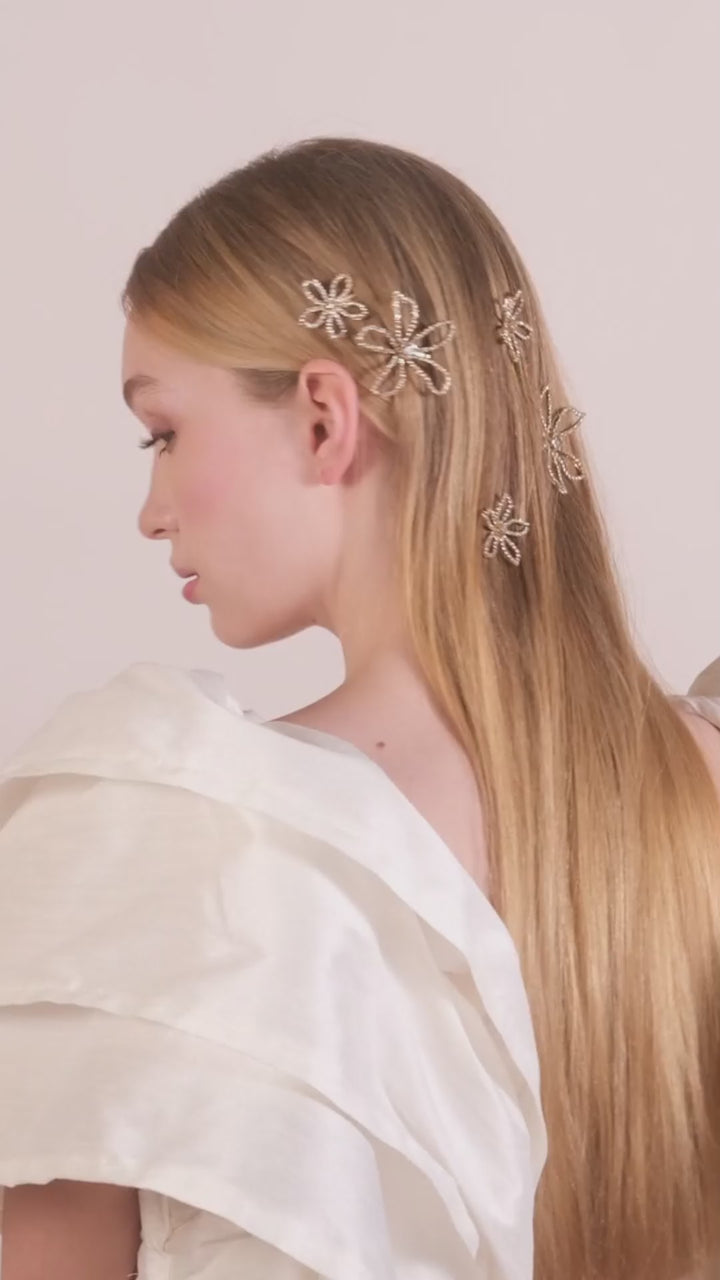 A lady wearing her hair down with a selection of scattered crystal floral bridal hair pins