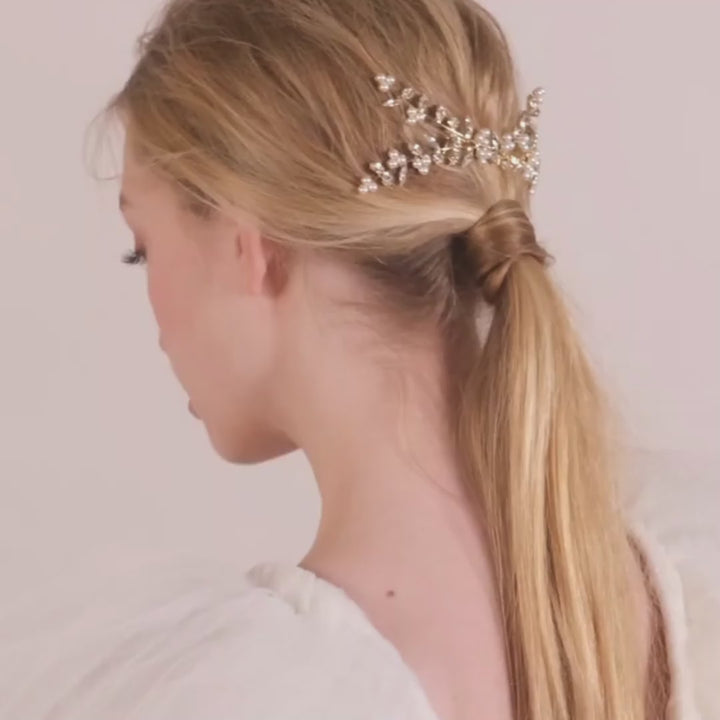 Pearl and crystal wedding hairpiece on lady in tulle dress