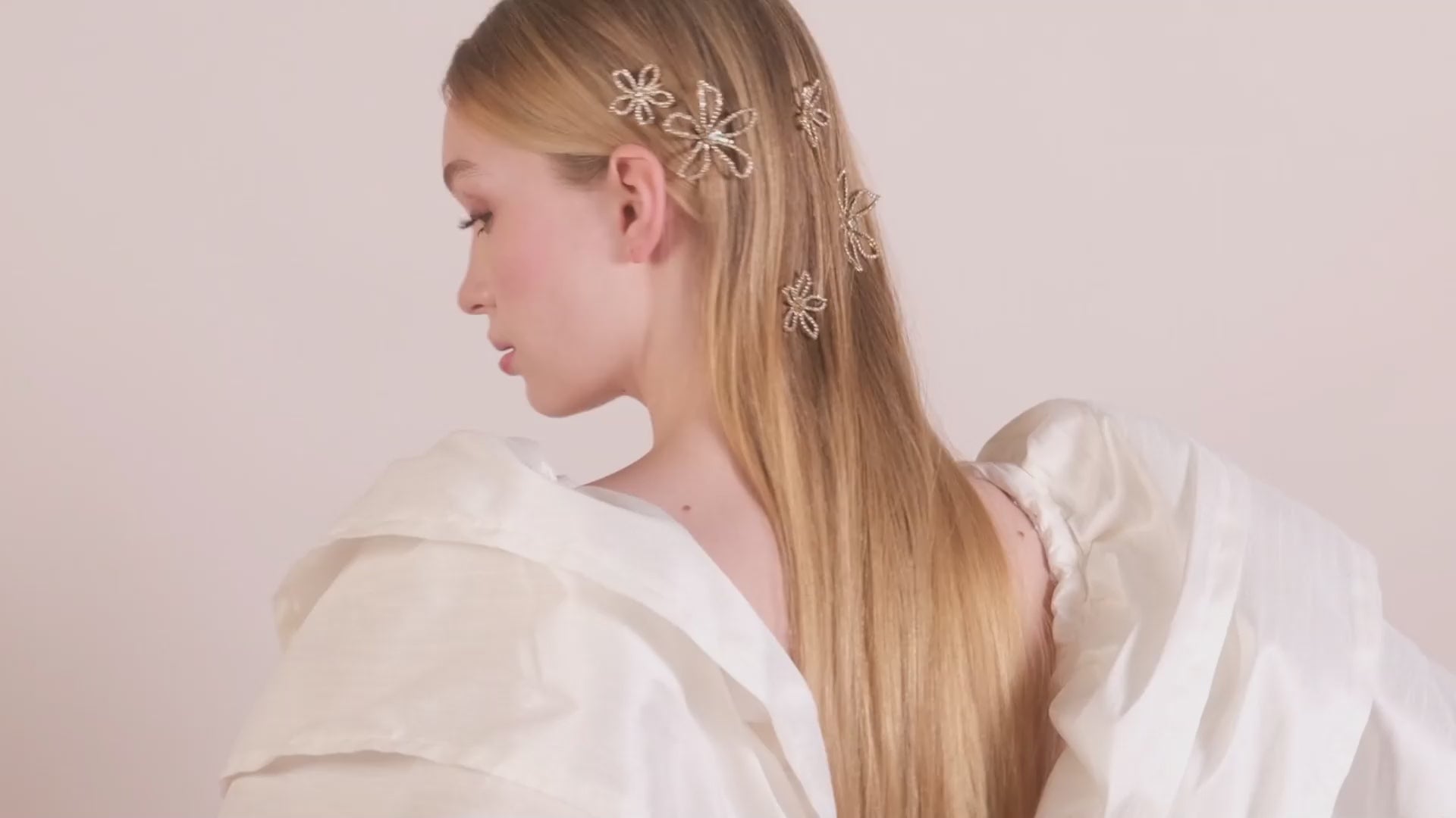 A lady wearing scattered crystal floral hair pins 