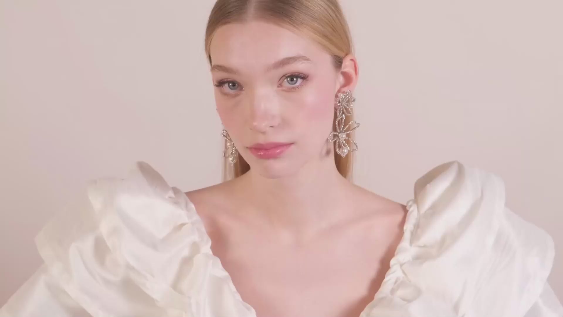 Lady wearing Floral crystal and pearl statement earrings 