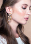Floral golden drop bridal earring with crystal  centers on model 