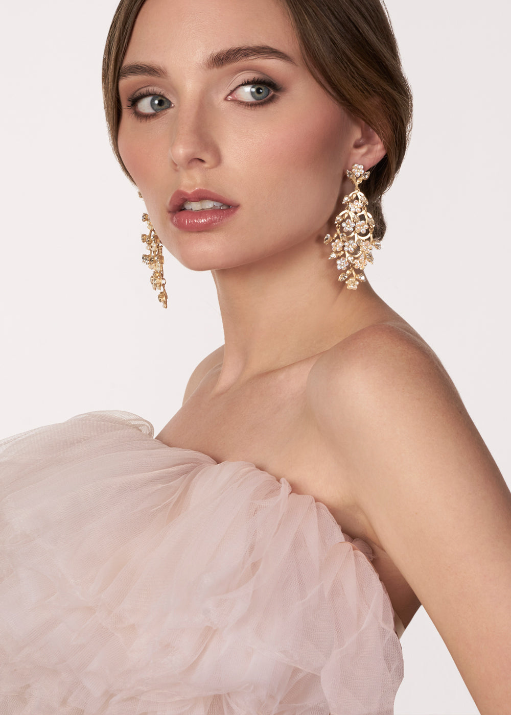 Crystal chandelier earring on model in blush tulle wedding dress 