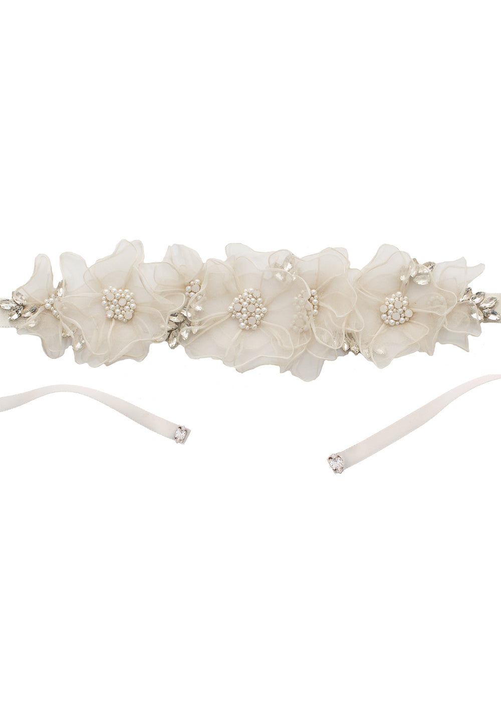 Floral silk wedding dress sash with crystal and pearls centers on a laid flat white background 