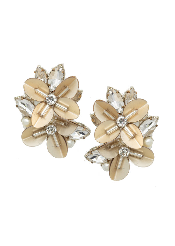 Floral clustered earring, made from gold sequins, pearls and crystals on a white background