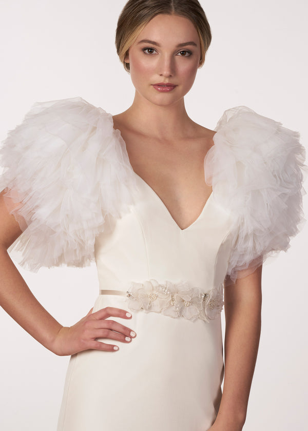 Floral silk wedding dress sash with crystal and pearls centers on a model in a tuell wedding dress 