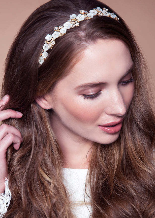 Floral golden wedding hairpiece on model portrait