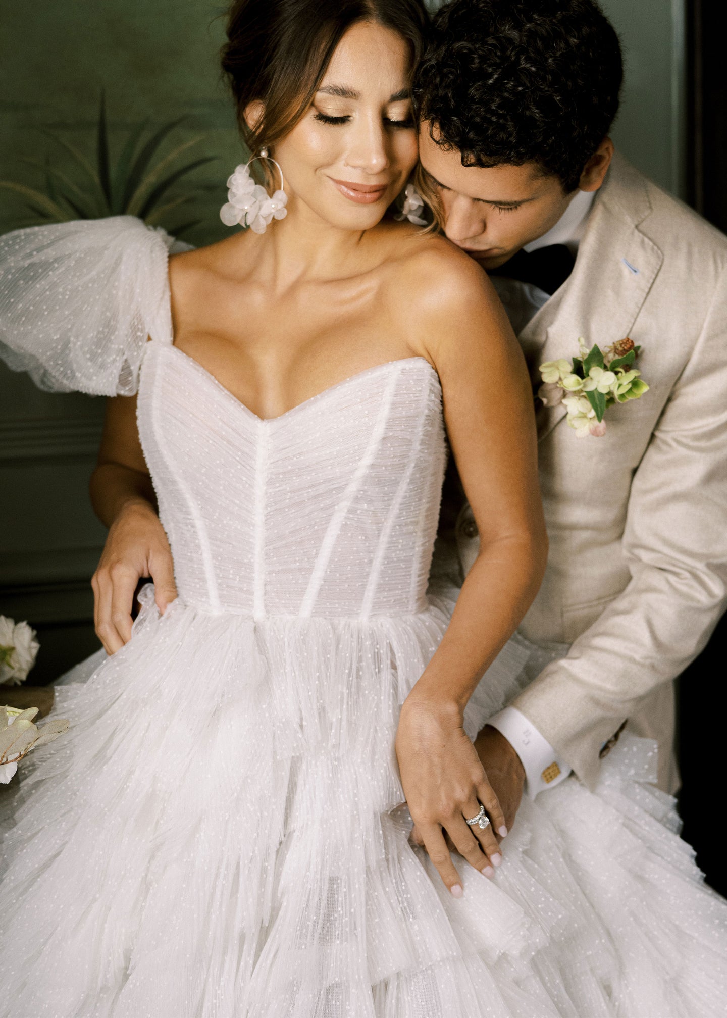 Silk floral hoop erring with pearl accents on bride in tulle gown