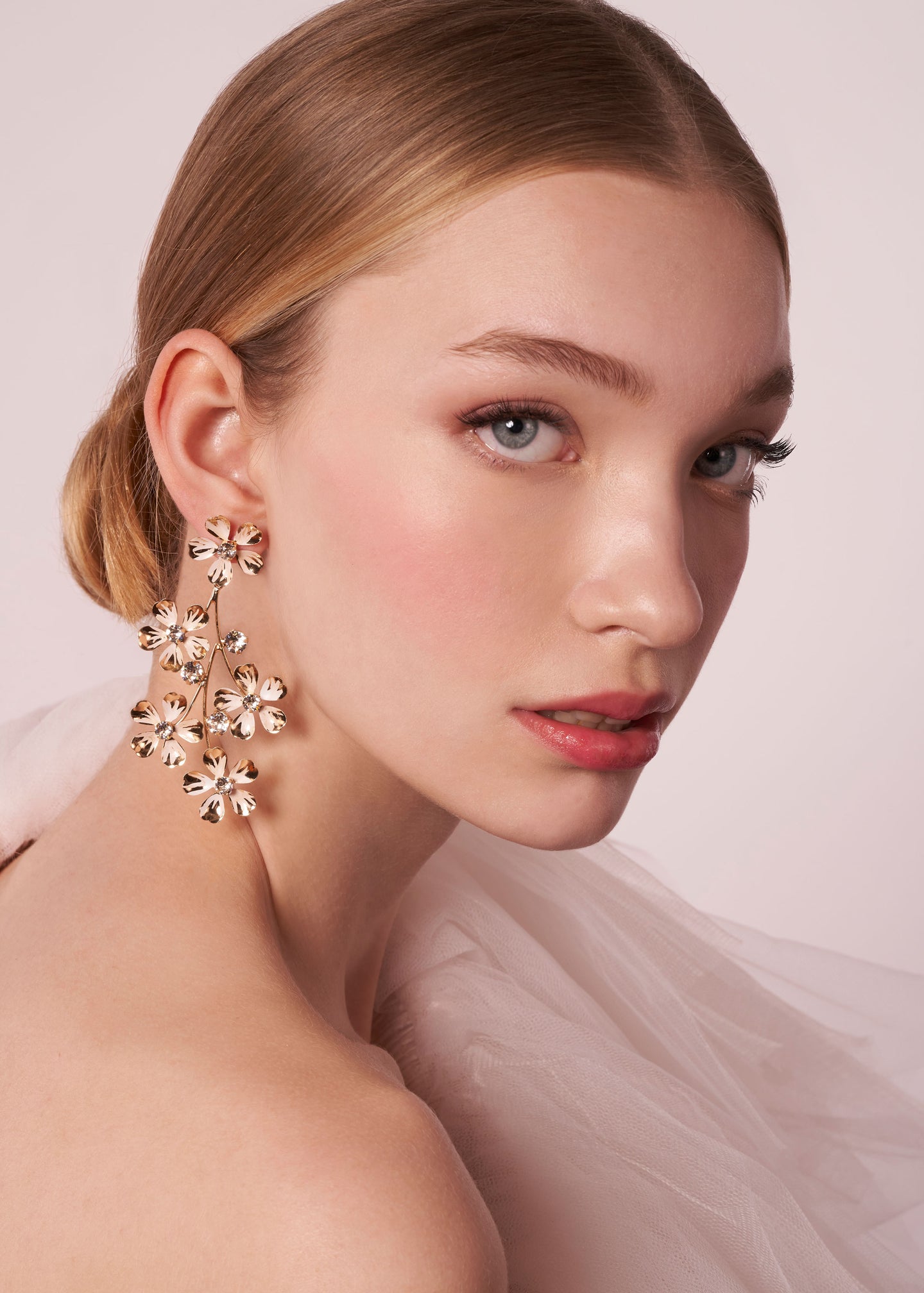Gold Floral crystal bridal chandelier earring on model in tulle dress (portrait)