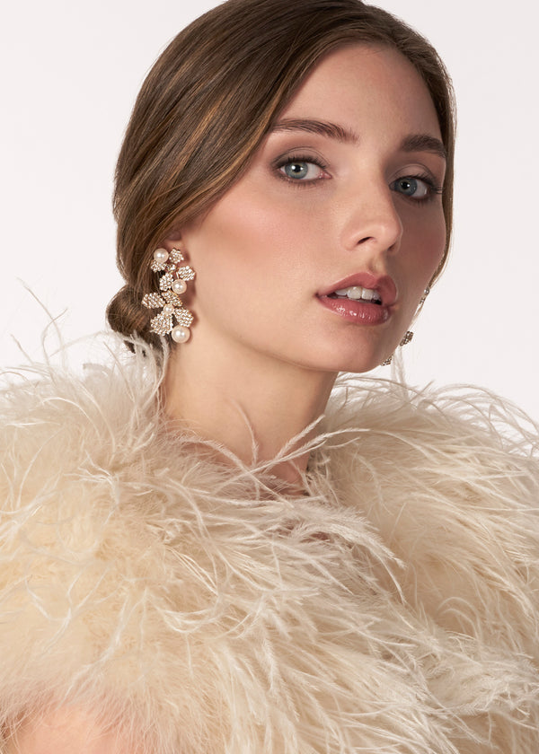 Gold crystal double flower earring with pearl accents on model side view 2 