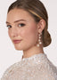 Long scattered pearl drop earring on  model side view 